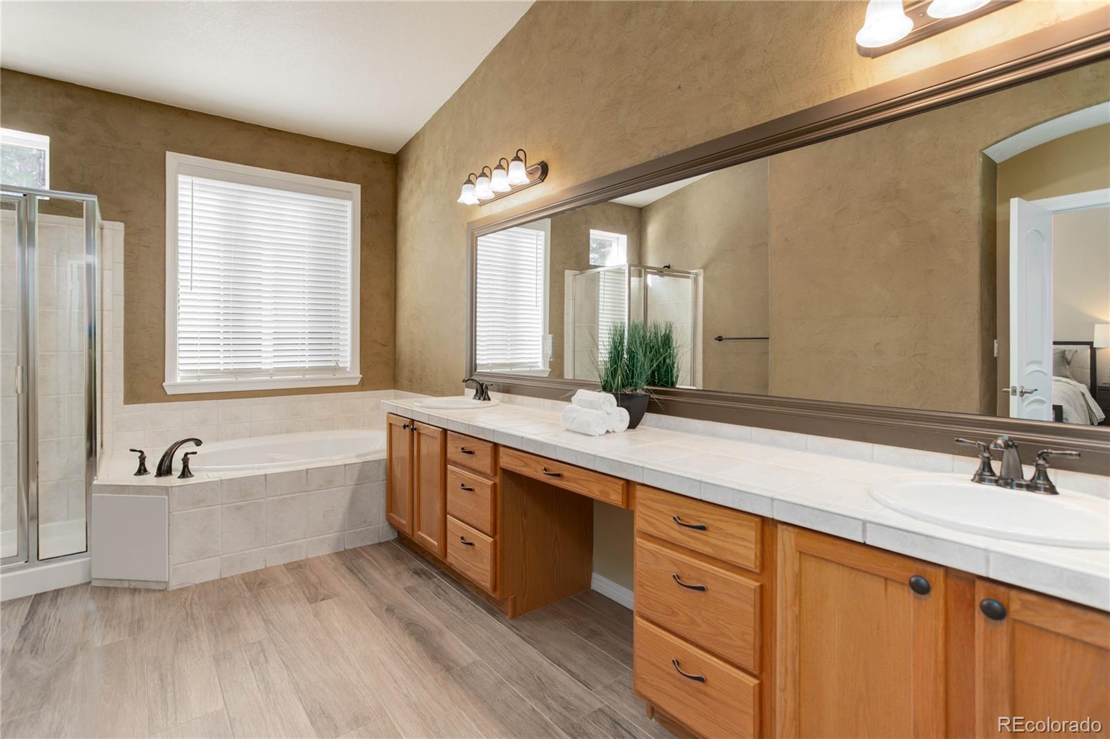 2720 Rockbridge Way Highlands Ranch, CO 80129 - Photo 23 of 39 a spacious bathroom with a double vanity sink a mirror and a bathtub