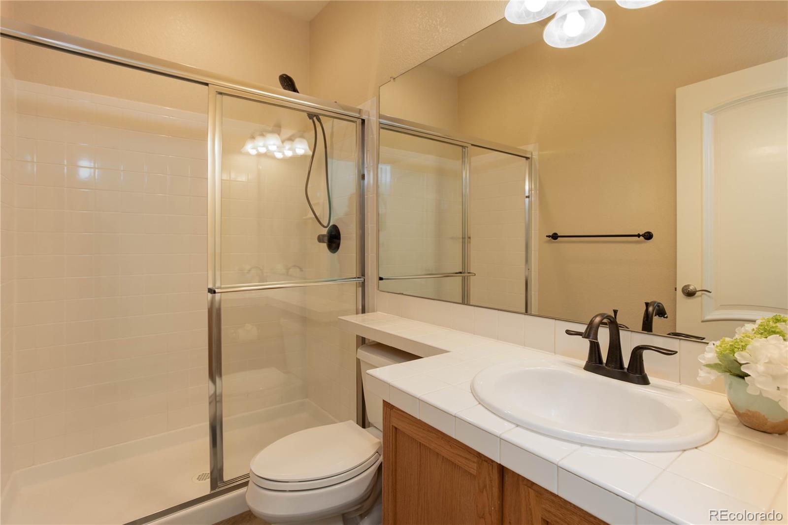 2720 Rockbridge Way Highlands Ranch, CO 80129 - Photo 26 of 39 a bathroom with a sink a toilet and shower