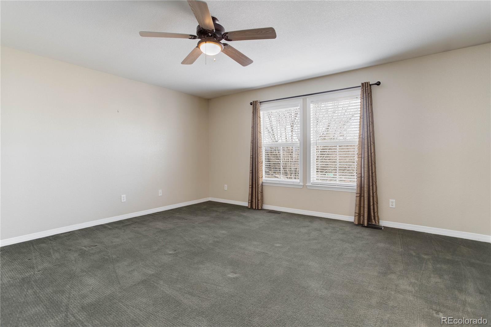 2720 Rockbridge Way Highlands Ranch, CO 80129 - Photo 27 of 39 an empty room with windows and fan
