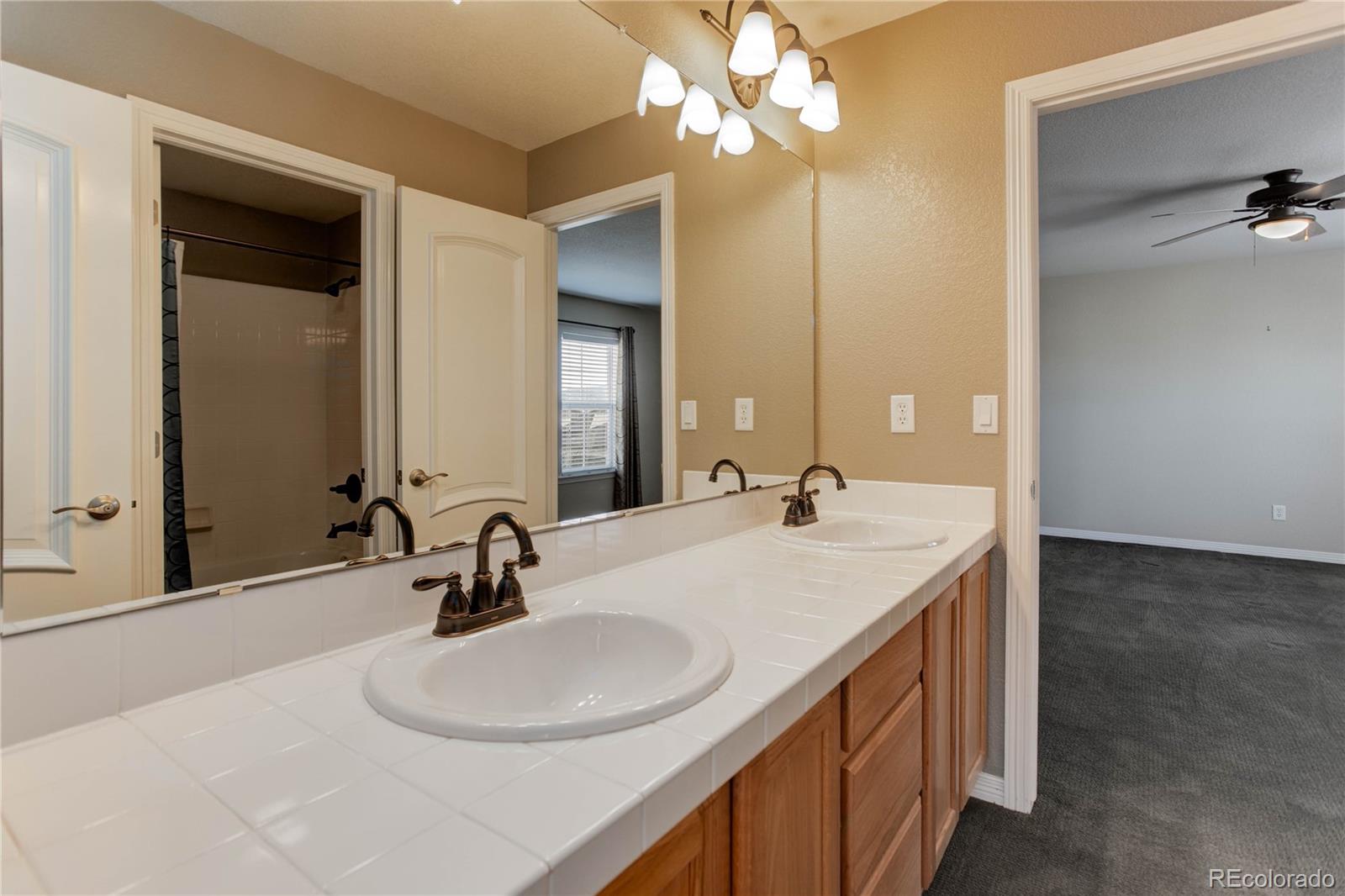 2720 Rockbridge Way Highlands Ranch, CO 80129 - Photo 29 of 39 a bathroom with a sink and a mirror