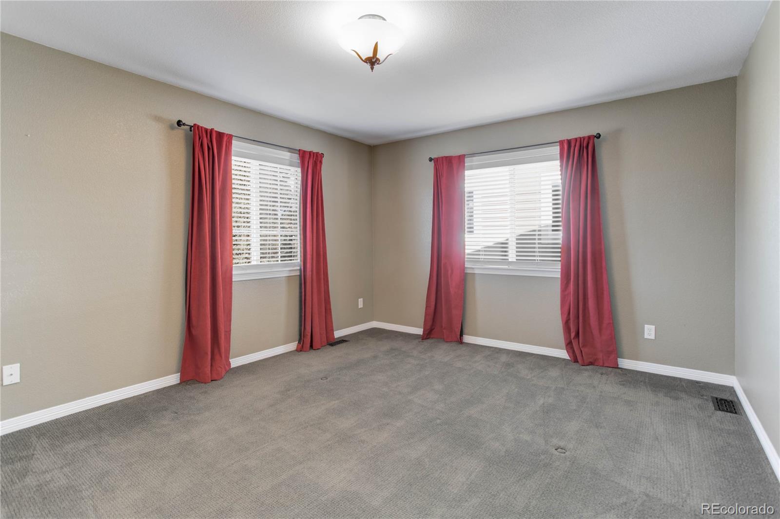 2720 Rockbridge Way Highlands Ranch, CO 80129 - Photo 30 of 39 an empty room with windows
