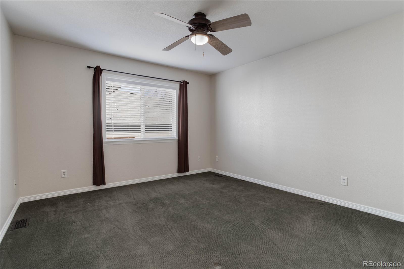 2720 Rockbridge Way Highlands Ranch, CO 80129 - Photo 32 of 39 an empty room with windows and fan