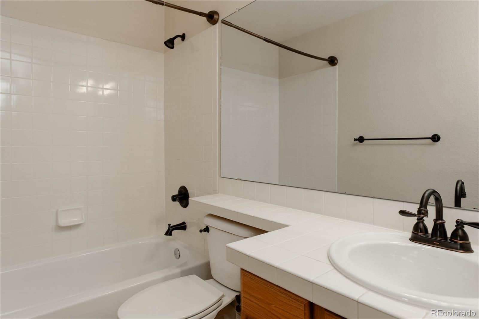2720 Rockbridge Way Highlands Ranch, CO 80129 - Photo 34 of 39 a bathroom with a sink a toilet and a bathtub