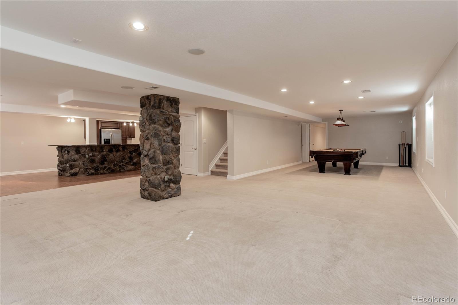 2720 Rockbridge Way Highlands Ranch, CO 80129 - Photo 37 of 39 a view of a kitchen with furniture and a refrigerator