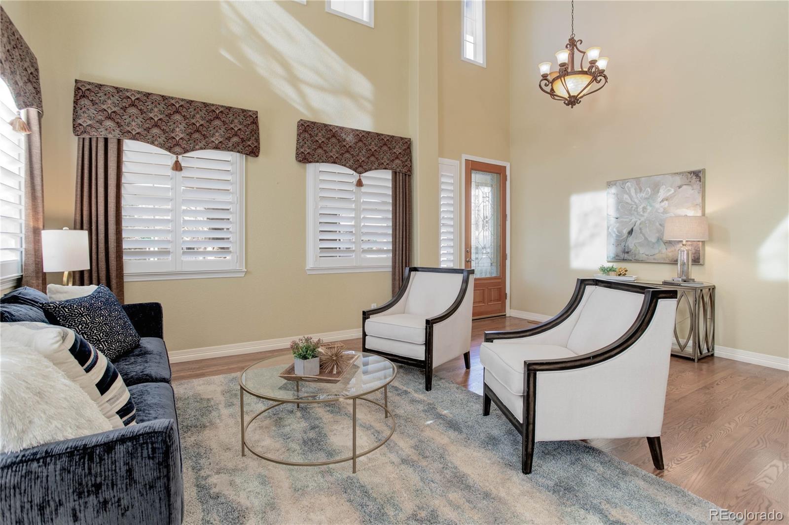 2720 Rockbridge Way Highlands Ranch, CO 80129 - Photo 8 of 39 a living room with furniture a bed and a window