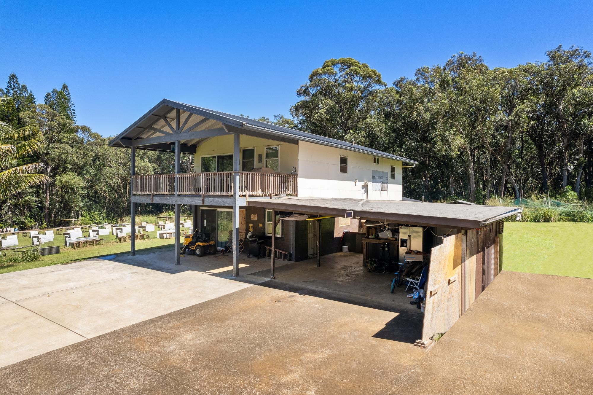 685 Upper Ulumalu Road Haiku, HI 96708 - Photo 20 of 34 a view of a house with a yard patio and slide