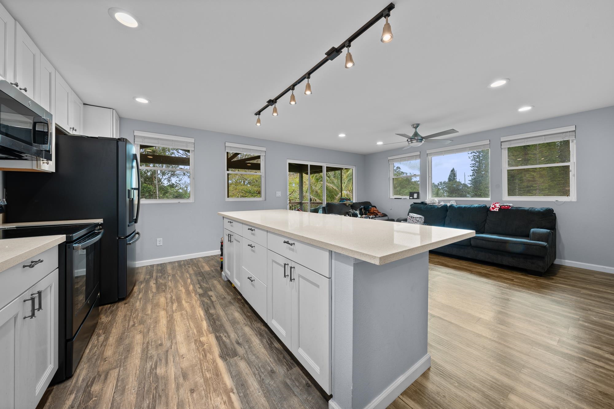 685 Upper Ulumalu Road Haiku, HI 96708 - Photo 2 of 34 a kitchen with stainless steel appliances kitchen island granite countertop a stove and a refrigerator