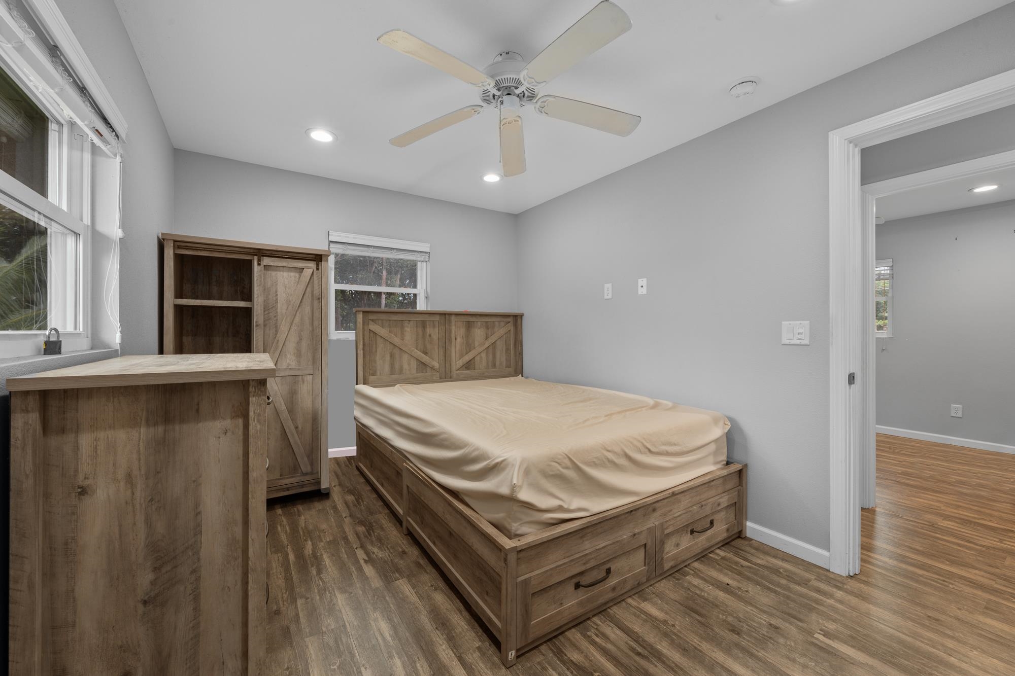 685 Upper Ulumalu Road Haiku, HI 96708 - Photo 6 of 34 a bedroom with a bed and a chandelier