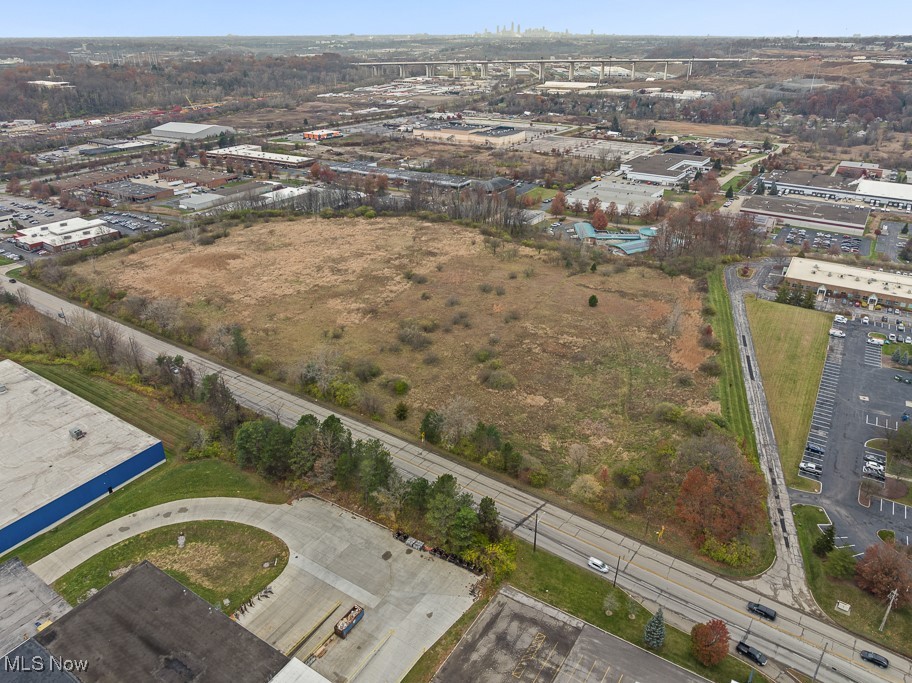 Aerial view of property and surrounding area featuring industrial structures