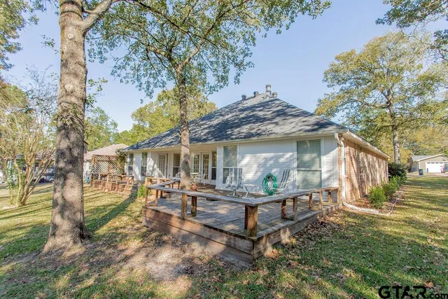 a view of a house with backyard and sitting area
