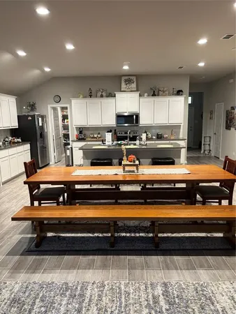 a view of kitchen with stainless steel appliances cabinets