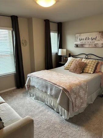 a bedroom with a bed and couch