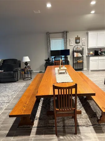 a room with furniture pool table and kitchen view