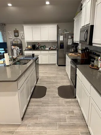 a view of a living room with furniture and a flat screen tv