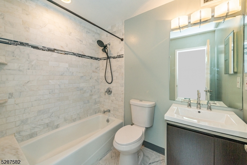 240 Main Street, Unit 313 Little Falls, NJ 07424 - Photo 12 of 21 a bathroom with a sink toilet and shower