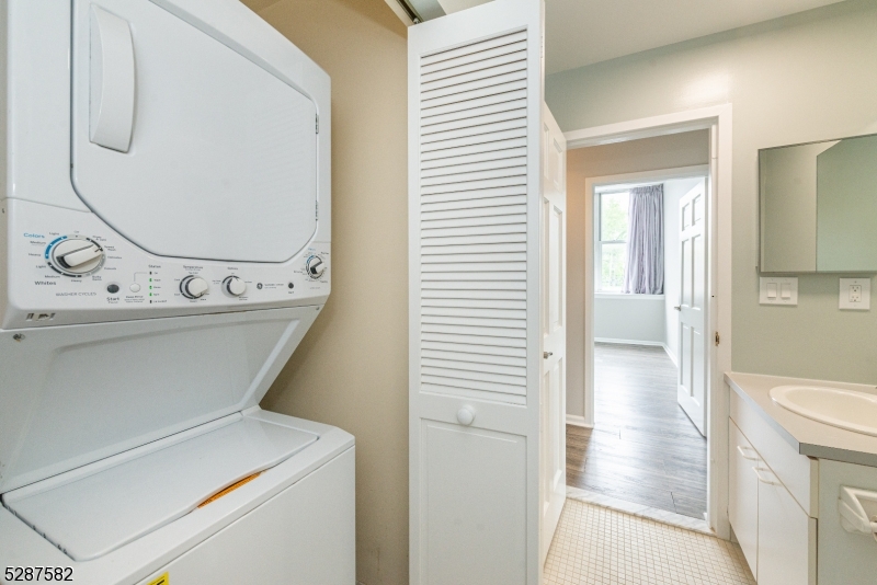 240 Main Street, Unit 313 Little Falls, NJ 07424 - Photo 18 of 21 a view of a hallway with washer and dryer
