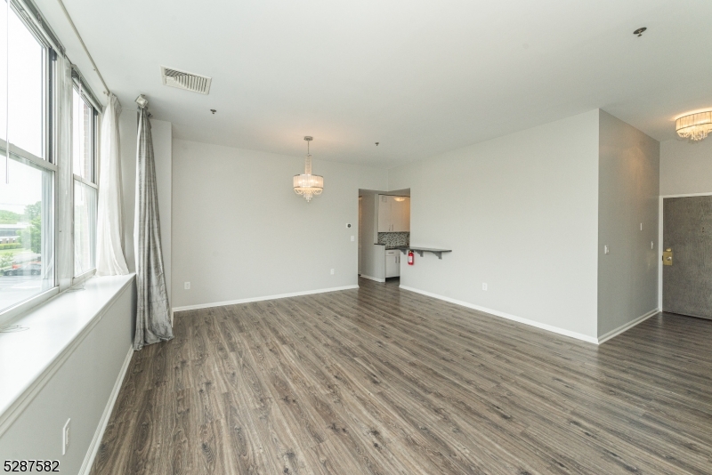 240 Main Street, Unit 313 Little Falls, NJ 07424 - Photo 19 of 21 a view of empty room with wooden floor and fan