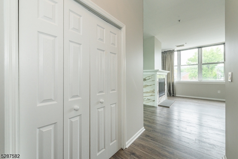 240 Main Street, Unit 313 Little Falls, NJ 07424 - Photo 20 of 21 wooden floor in an empty room with a window