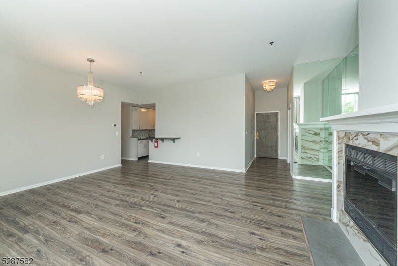 240 Main Street, Unit 313 Little Falls, NJ 07424 - Photo 5 of 21 a view of a livingroom with a fireplace