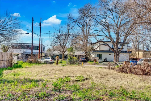 a view of a house with a yard covered in snow