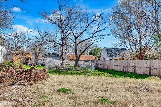 a view of a backyard with a large tree