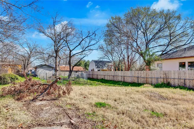 a view of a backyard with large trees and a small yard
