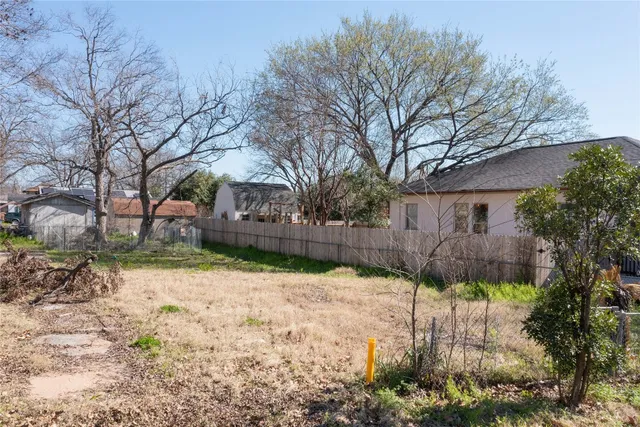 a backyard of a house with a large tree