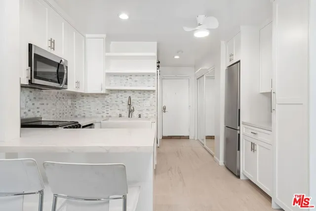 a kitchen with a stove a sink and a microwave