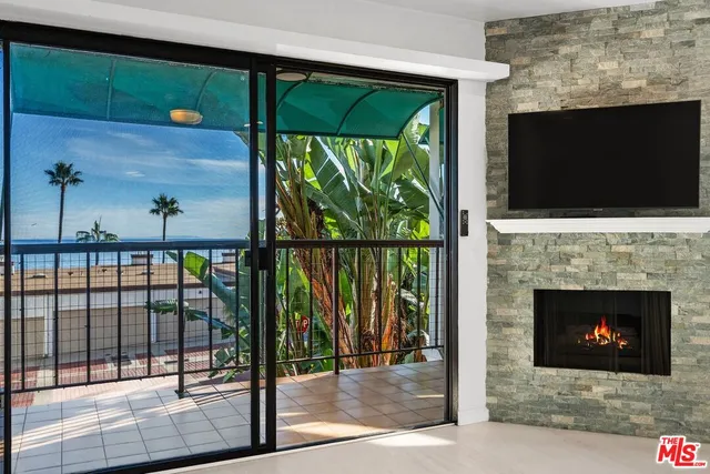 a living room with a fireplace and a flat screen tv