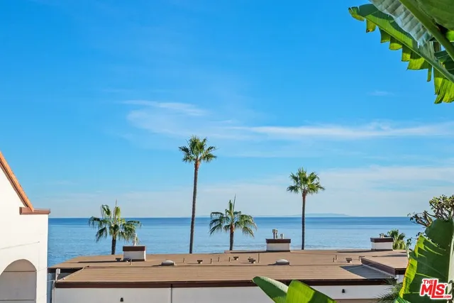 an empty room with fireplace chandelier and windows