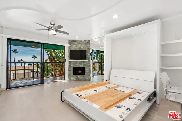 a large white kitchen with a white stove top oven and chandelier