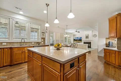 a kitchen with stainless steel appliances granite countertop a sink a stove and a refrigerator