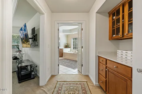 a view of a hallway to a livingroom and a livingroom with furniture