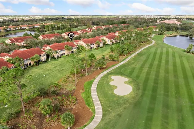 an aerial view of residential houses with outdoor space and trees