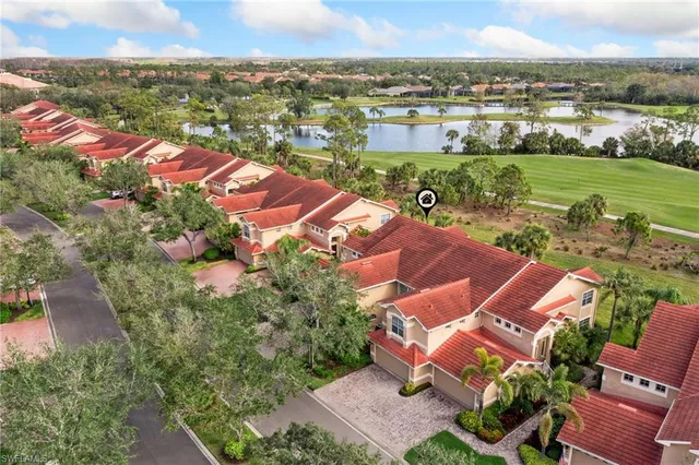an aerial view of residential houses with outdoor space and river