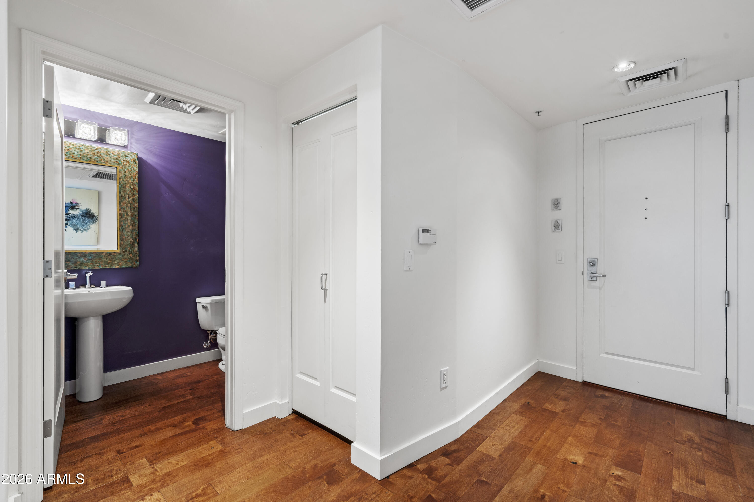310 South 4th Street, Unit 601 Phoenix, AZ 85004 - Photo 9 of 29 a view of hallway with walk in closet and wooden floor