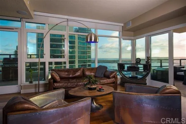 a living room with furniture and a floor to ceiling window