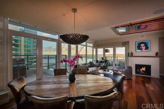a dining room with furniture window and wooden floor