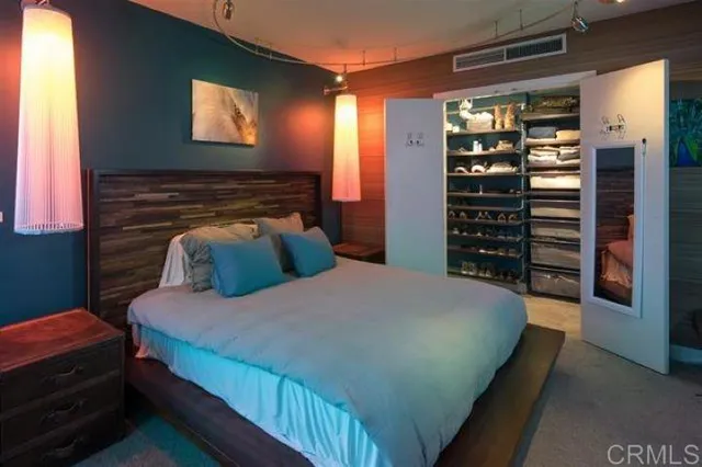 a bathroom with a double vanity sink a toilet and a bathtub