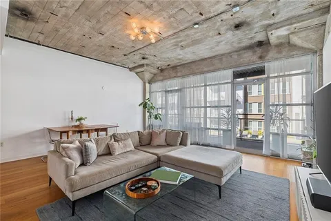 a living room with furniture and wooden floor