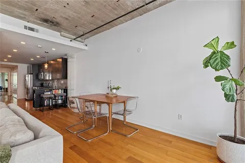 a view of a dining room with furniture window and wooden floor