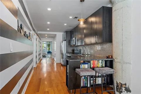 a kitchen with stainless steel appliances granite countertop a stove a sink and a refrigerator