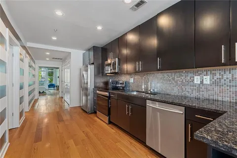 a kitchen with stainless steel appliances a refrigerator and a stove