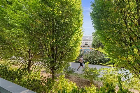 a bathroom with a granite countertop bathtub sink double vanity and mirror