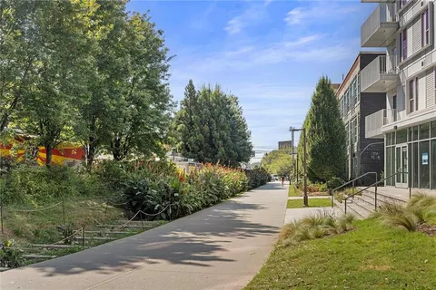 a backyard of a house with barbeque oven table and chairs