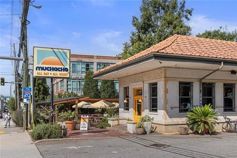 a view of a large building with a lot of flower plants