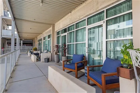 a building outdoor space with patio furniture and potted plants