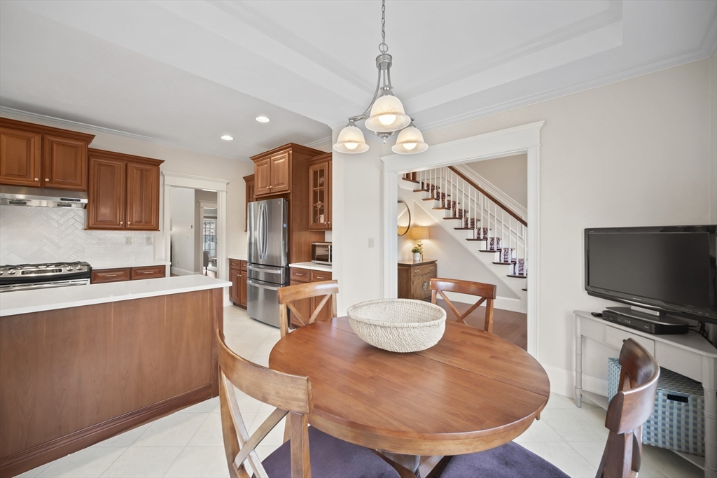 30 Nobscot Road, Unit 1 Sudbury, MA 01776 - Photo 11 of 42 a view of a dining room with furniture a chandelier and wooden floor