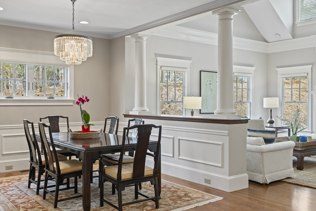 30 Nobscot Road, Unit 1 Sudbury, MA 01776 - Photo 16 of 42 a view of a dining room with furniture wooden floor and a chandelier