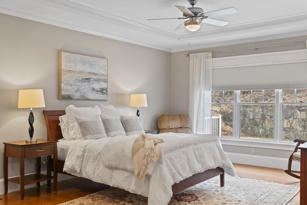 30 Nobscot Road, Unit 1 Sudbury, MA 01776 - Photo 21 of 42 a spacious bedroom with a bed and a chandelier